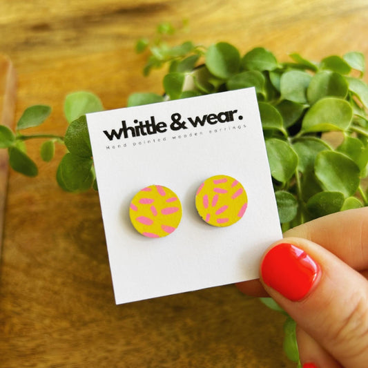 Round studs. Yellow with pink dashes