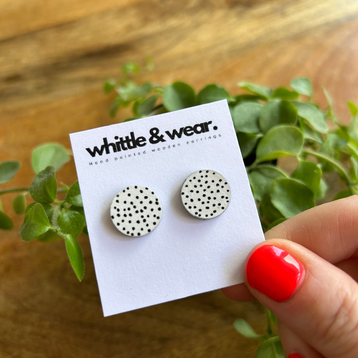 Round studs. White with black spots